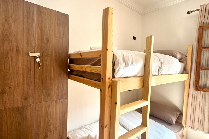 Women-only dorm at the Tamraght hostel: a pine bunk bed and a wooden wardrobe
